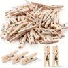 A pile of wooden mini clothespins in natural wood color, used for crafts and photo displays.