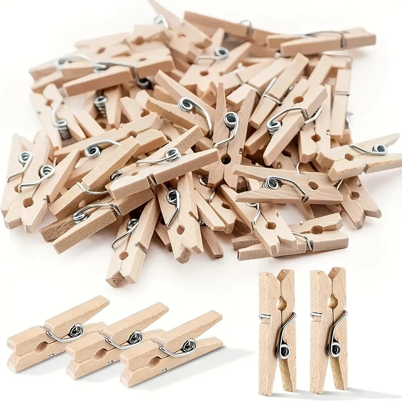 A pile of wooden mini clothespins in natural wood color, used for crafts and photo displays.