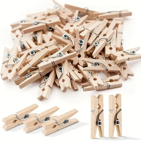 A pile of wooden mini clothespins in natural wood color, used for crafts and photo displays.