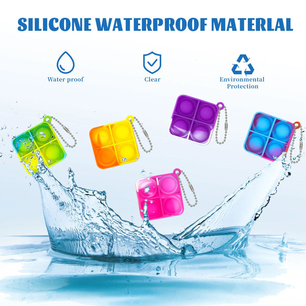 Colorful silicone waterproof fidget keychains floating in water, demonstrating waterproof protection.