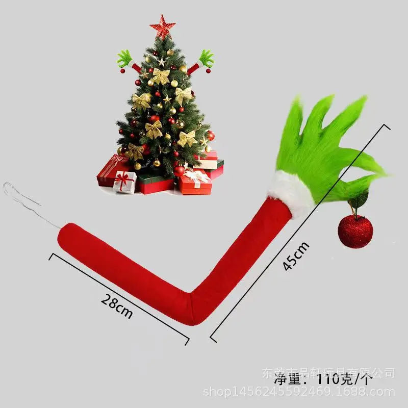 A red arm shaped like a monster with a green hand and a red Christmas tree decoration.