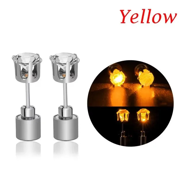 A pair of silver LED light-up flashing stud earrings with color-changing zircon stones shown against a dark background.