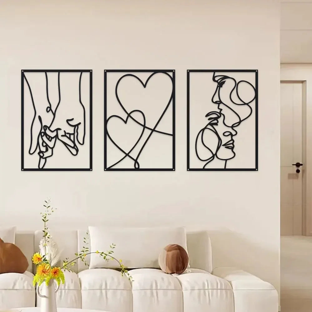 A set of three black metal line art prints depicting holding hands, a heart, and a profile face.