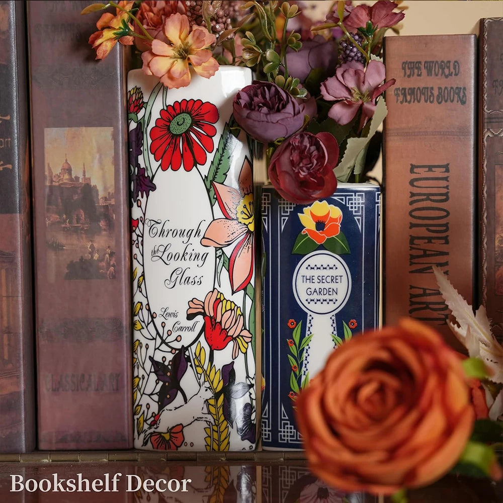 A display of ceramic book-shaped vases featuring vintage finishes and floral arrangements.