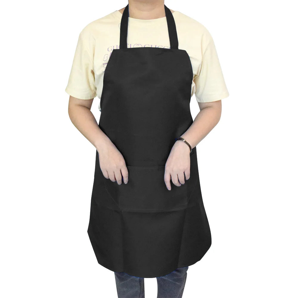A person wearing a black waterproof kitchen apron with a front pocket over a light yellow shirt.