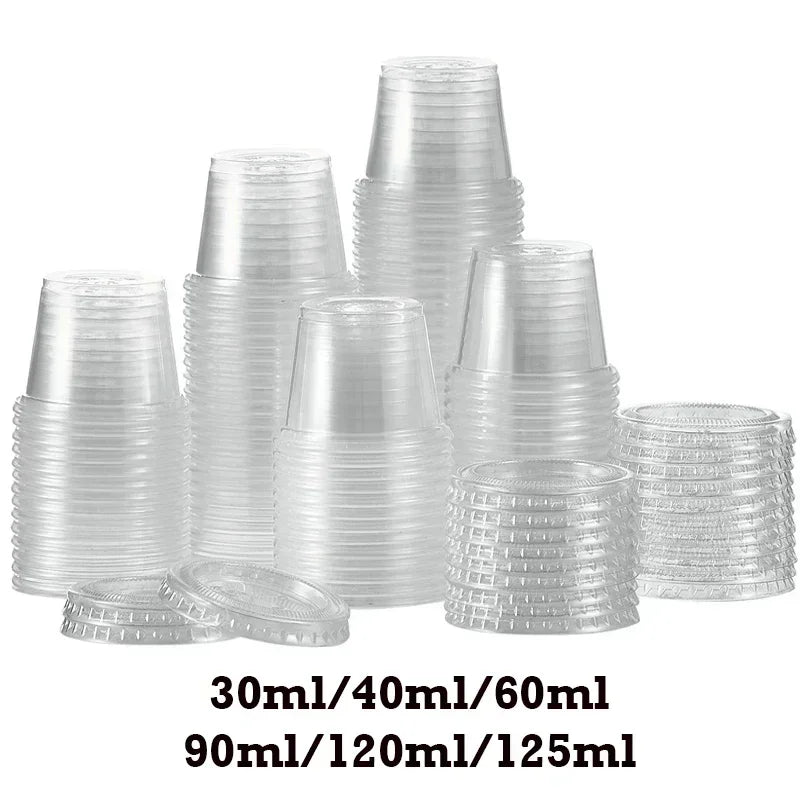 A collection of clear plastic sauce cups and lids in various sizes stacked on a white background.