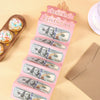 A pink birthday cash gift envelope with a cake design featuring US dollar bills and portraits of historical figures.