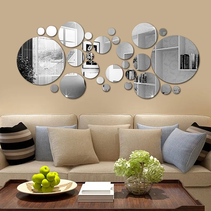 A wall display featuring a collection of round acrylic mirror stickers in various sizes and finishes on a beige wall.