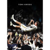 A black and white portrait of a soccer player in action, signed by Toni Kroos.