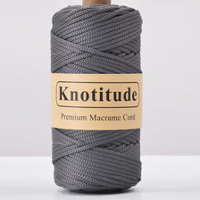 A spool of grey Knotitude Premium Macrame Cord for knitting and DIY crafts.