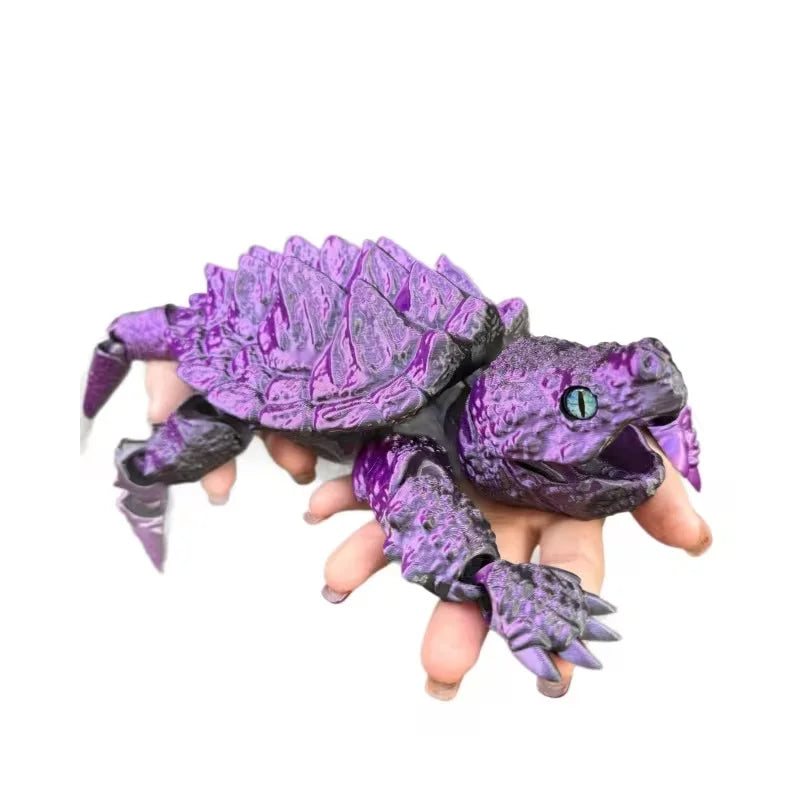 A purple 3D printed alligator snapping turtle figurine with articulated joints held in a hand.