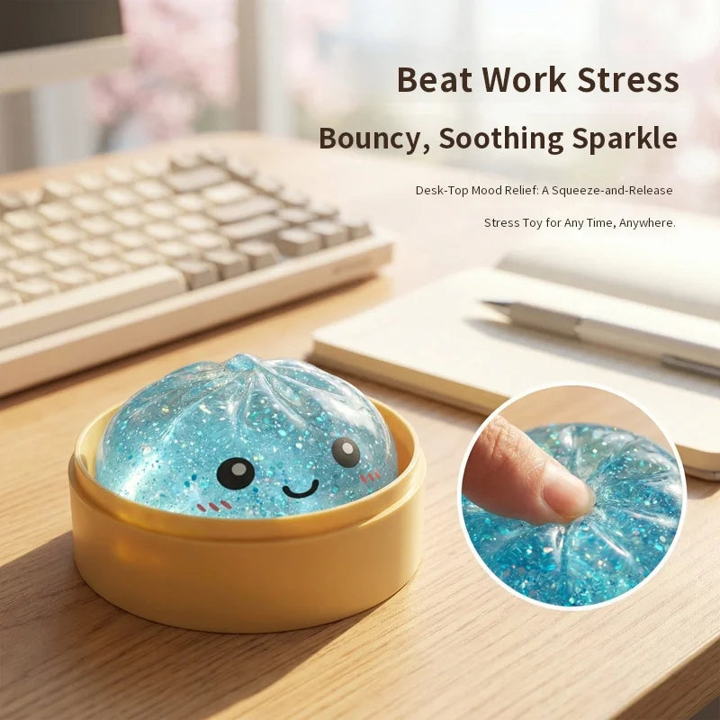 A glowing blue squishy toy shaped like a dumpling resting in a yellow dish on a wooden desk.