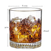 A clear whiskey glass filled with amber liquid and large ice cubes, showing the glass dimensions.