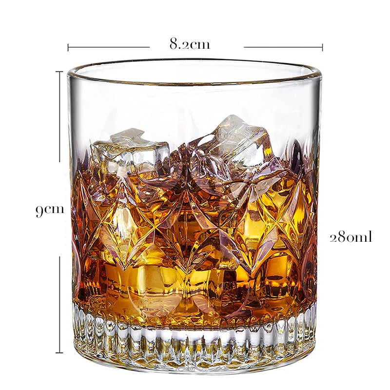 A clear whiskey glass filled with amber liquid and large ice cubes, showing the glass dimensions.