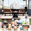 A collection of Jujutsu Kaisen blind box figures, including a large white figure with black hair and various smaller characte