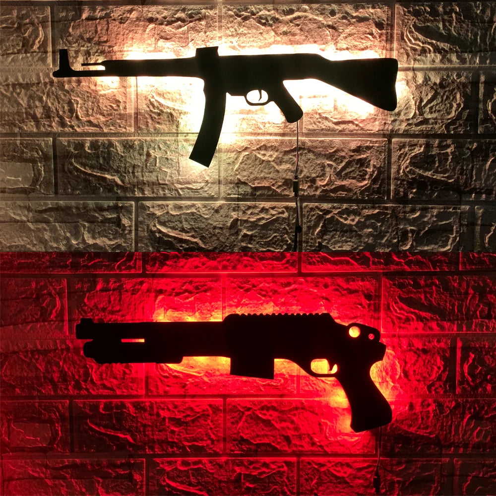 A black gun-shaped LED light fixture mounted on a brick wall, illuminated in orange and red tones.