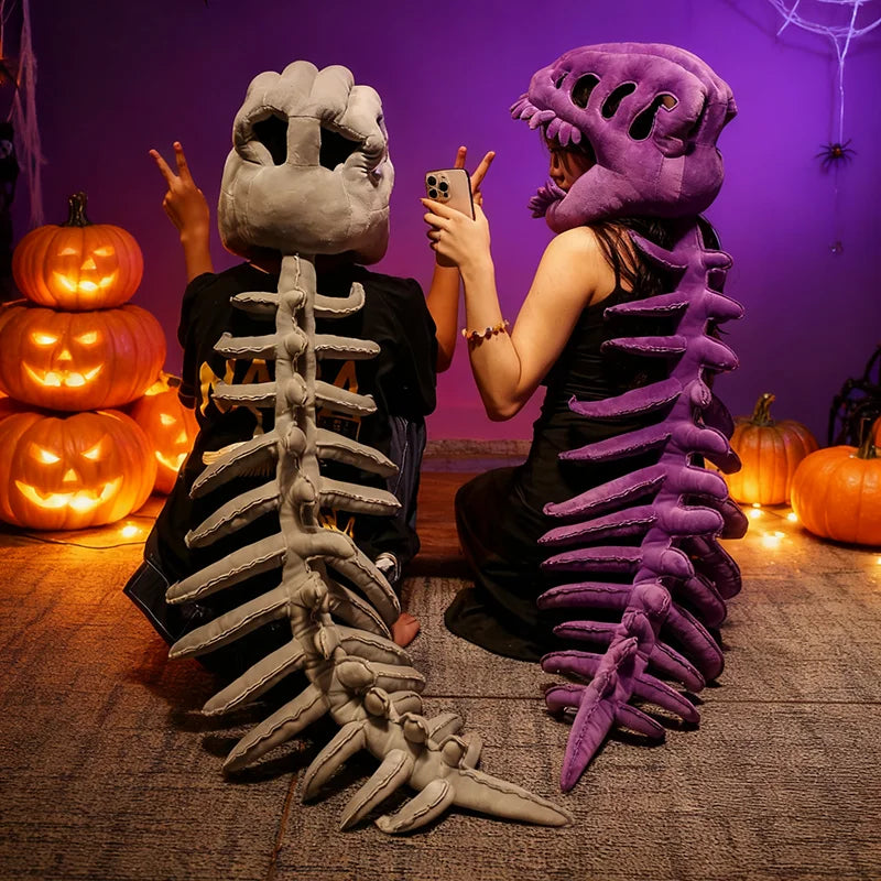 A person wearing a realistic dinosaur skeleton costume, including a headpiece and rib cage, posing in a purple-lit room.