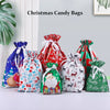 A set of five festive drawstring Christmas candy bags featuring Santa, snowmen, and winter designs in red, blue, and green.