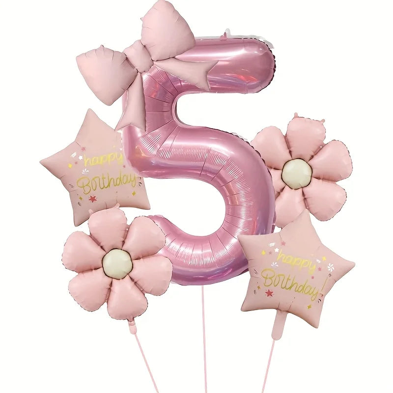 Pink foil balloons shaped like the number 5 and a flower, used for birthday celebrations.