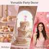 A tiered pink birthday cake decorated with roses and a number seven, set against a soft pink background.