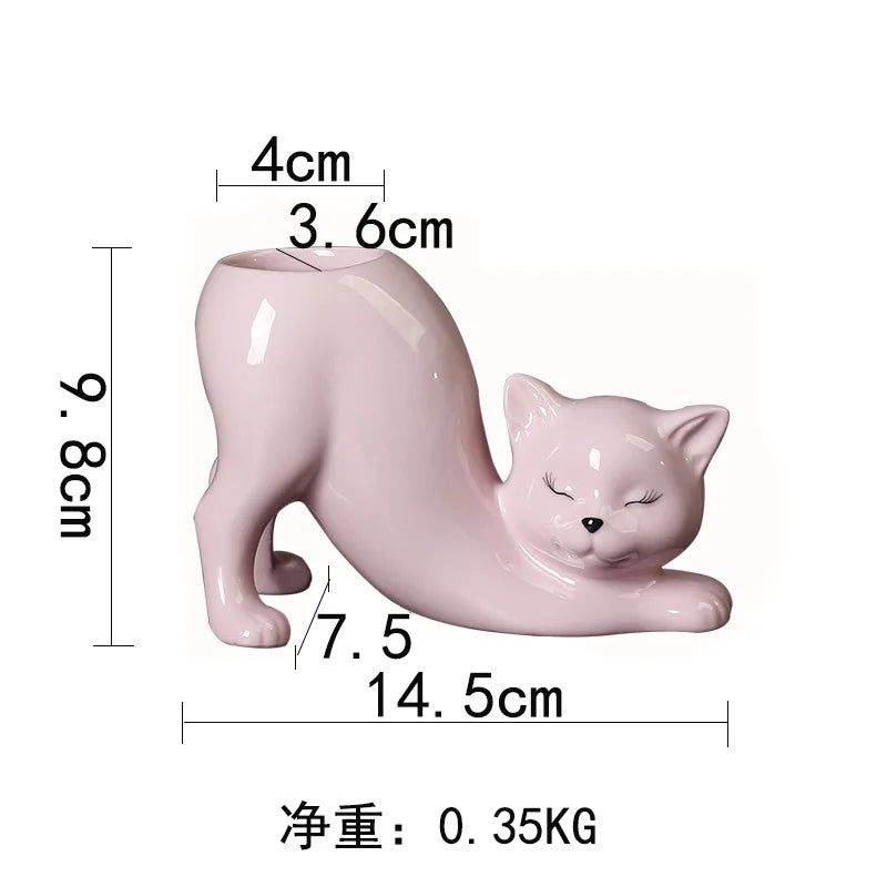 A pink cartoon cat planter shaped like a sleeping cat with a long tail, measuring 9.8cm high and 14.5cm long.