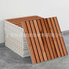 Wooden slatted paneling and white tile accents displayed on a gray surface.