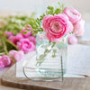 A pink rose bouquet in a glass vase with an acrylic heart keepsake plaque for him