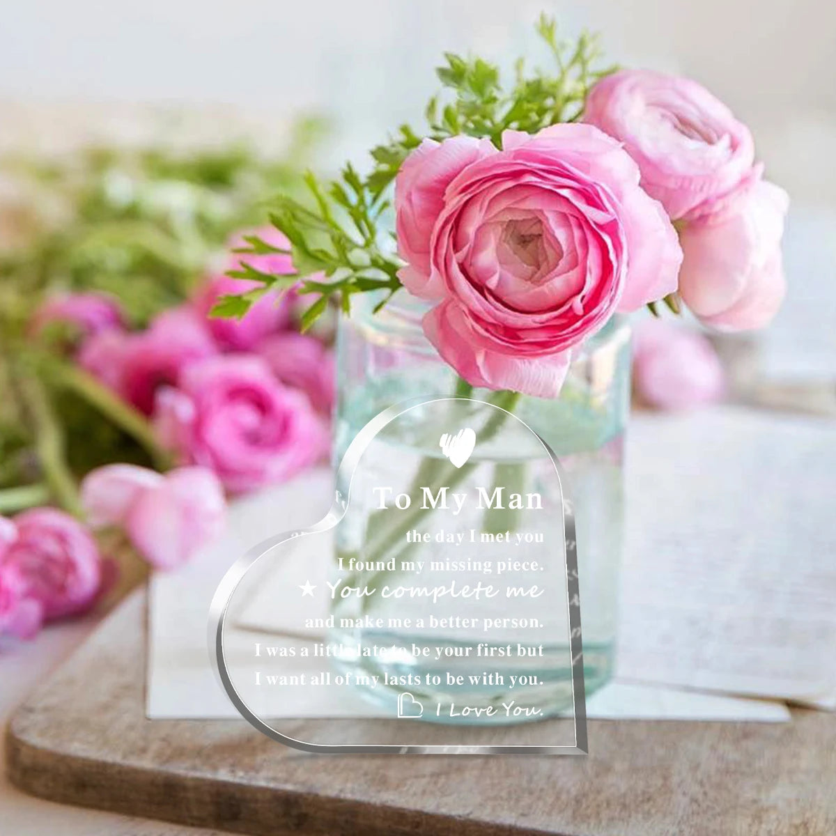A pink rose bouquet in a glass vase with an acrylic heart keepsake plaque for him