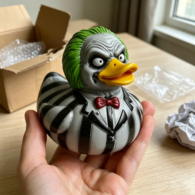 A hand holds a gray and black striped resin figurine of a duck with green feathers and an orange beak.