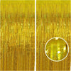 A close-up of a metallic gold foil tinsel fringe backdrop set with vertical strands.