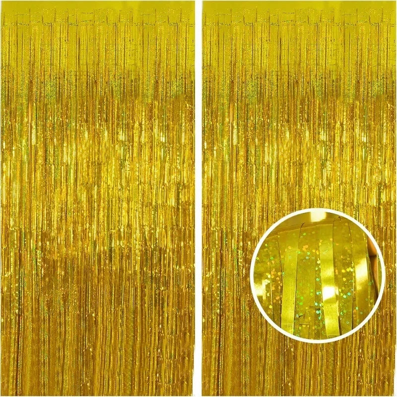 A close-up of a metallic gold foil tinsel fringe backdrop set with vertical strands.
