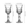 A pair of vintage French-style high-footed wine glasses shown in a side view.