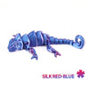 A silicone dragon lizard figurine in silk red-blue color, coiled and detailed.