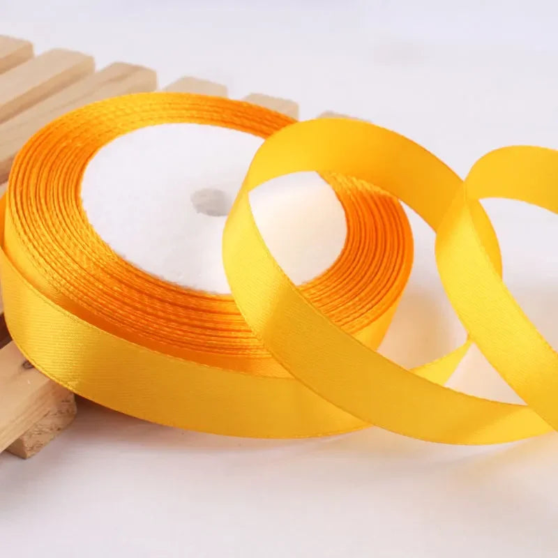 Roll of gold yellow satin ribbon for crafts and gift wrapping