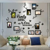 A wall display featuring black silhouette tree decals and framed photos on a light gray wall.