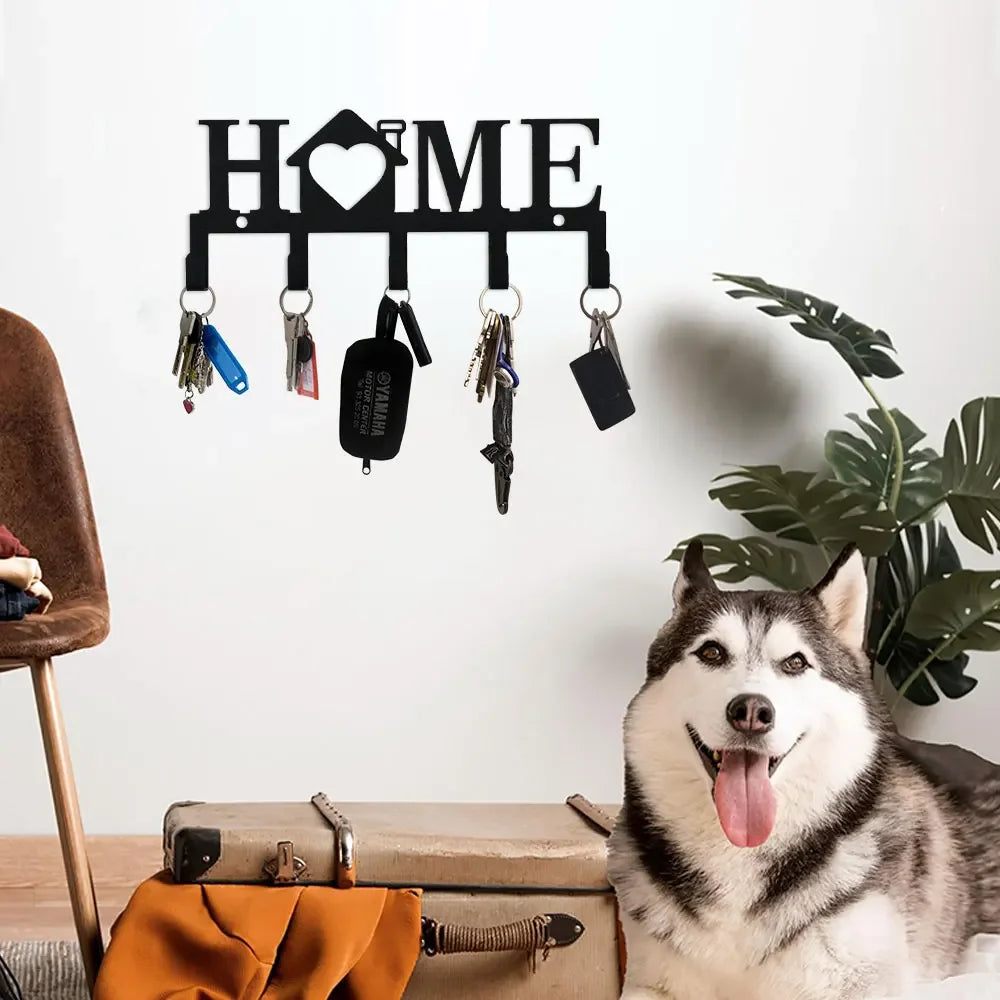 A white husky dog sits next to a black wall key holder with hooks on a light gray background.