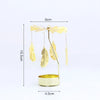 A gold rotating candle holder with a spinning carousel of feathers and a base.