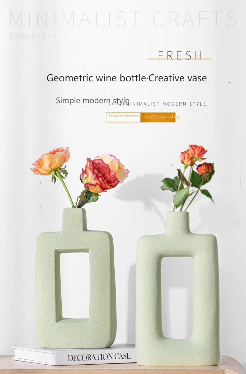 A light green geometric ceramic vase with a rectangular opening displayed on a white background.