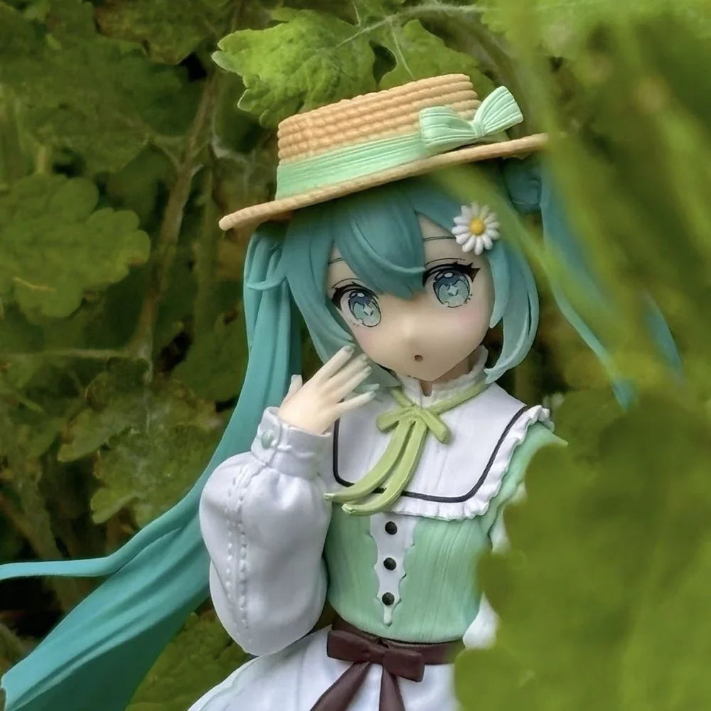A PVC collectible figurine of Hatsune Miku with teal hair wearing a green outfit and straw hat.