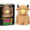 A fluffy brown Scottish Highland cow squishy stress relief toy in its packaging.