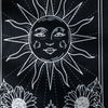 Black sun and moon boho wall tapestry featuring a stylized sun radiating light and sunflowers