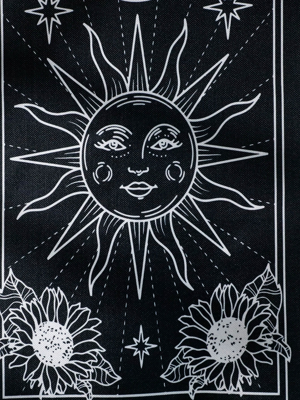 Black sun and moon boho wall tapestry featuring a stylized sun radiating light and sunflowers