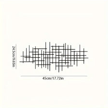 Abstract sculpture of geometric metal lines forming a textured wall art piece.