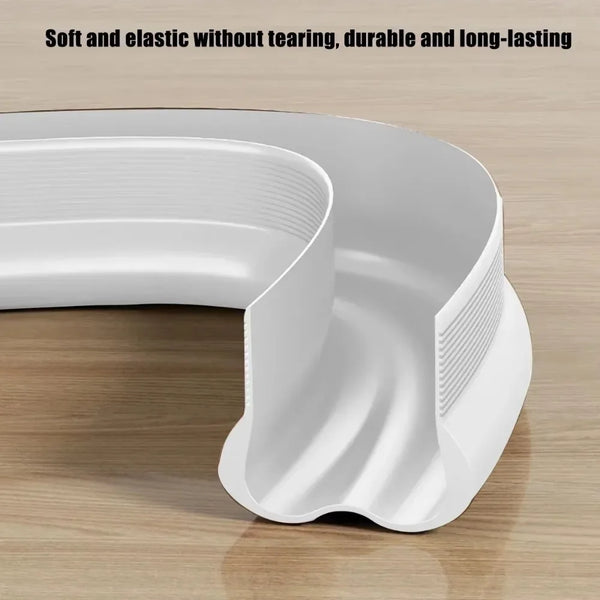 A white, flexible door bottom seal strip shown in a curved shape on a wooden surface.