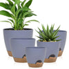 A set of five gray self-watering flower pots for indoor plants with natural fiber accents.