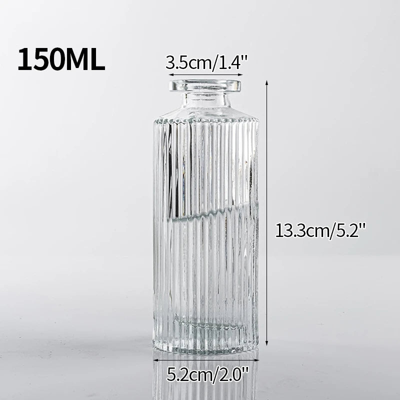 A tall, cylindrical clear glass bottle with vertical ridges, measuring 150ml.
