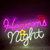 Neon sign spelling out Heavens Night in pink and white with a yellow star glow