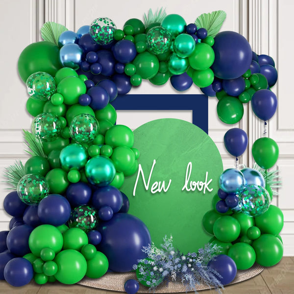 A vibrant balloon arch set featuring green and purple balloons with silver accents, arranged in a decorative frame.