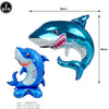 A shiny blue shark foil balloon is shown, with a smaller version also visible, used for ocean-themed party decoration.