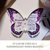 A clear acrylic butterfly keepsake with purple and white wings engraved with the message I love you Grandma I love you.